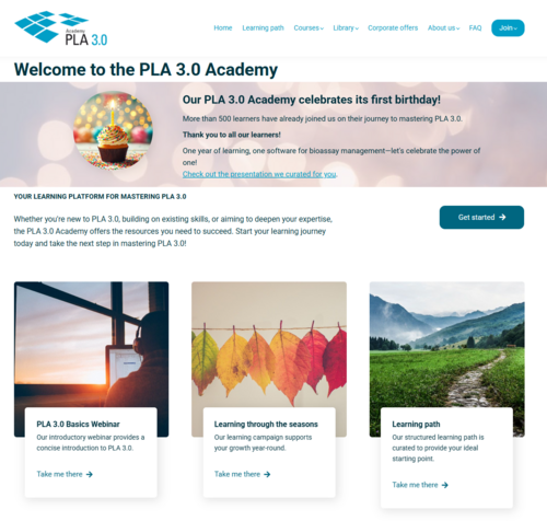 Banner with a blurred bokeh background and a cupcake topped with a lit candle, celebrating the PLA 3.0 Academy's first birthday. Below, three learning cards: the first shows a person working on a laptop near a window at sunset, labeled "PLA 3.0 Basics Webinar – Our introductory webinar provides a concise introduction to PLA 3.0." The second displays autumn leaves transitioning from green to red, labeled "Learning through the seasons – Our learning campaign supports your growth year-round." The third features a winding dirt path through a green field with mountains in the background, labeled "Learning path – Our structured learning path is curated to provide your ideal starting point."